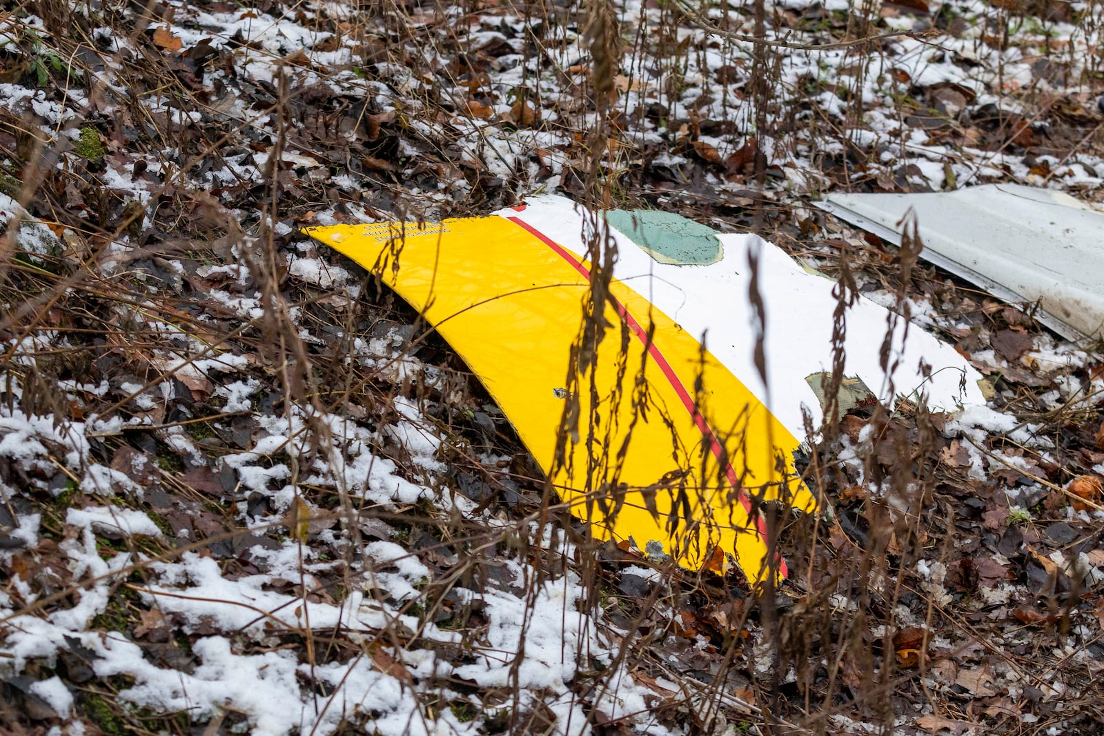 A piece of debris from a DHL cargo plane which crashed into a house is seen near the Lithuanian capital Vilnius, Lithuania, Monday, Nov. 25, 2024. (AP Photo/Mindaugas Kulbis)