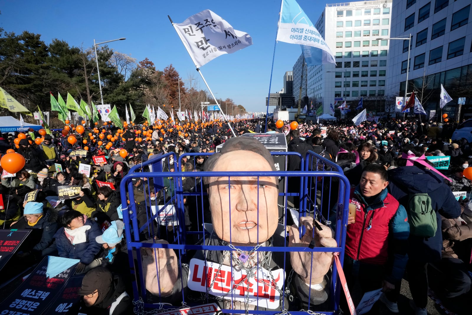 A caricature depicting an imprisoned South Korean President Yoon Suk Yeol is displayed before a rally to demand his impeachment outside the National Assembly in Seoul, South Korea, Saturday, Dec. 14, 2024. (AP Photo/Ahn Young-joon)