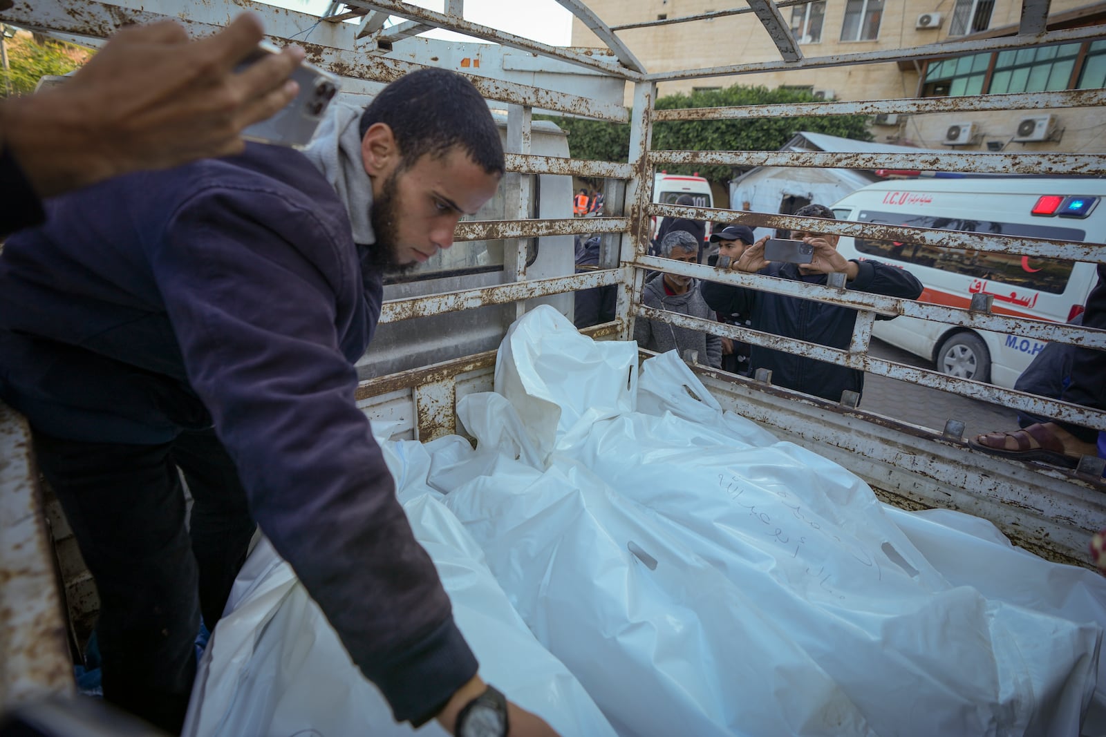 Bodies of victims of an Israeli airstrike at the Nuseirat arrive at the Al-Aqsa Martyrs hospital before their funeral in Deir al-Balah, Gaza Strip, Saturday, Dec. 21, 2024. (AP Photo/Abdel Kareem Hana)