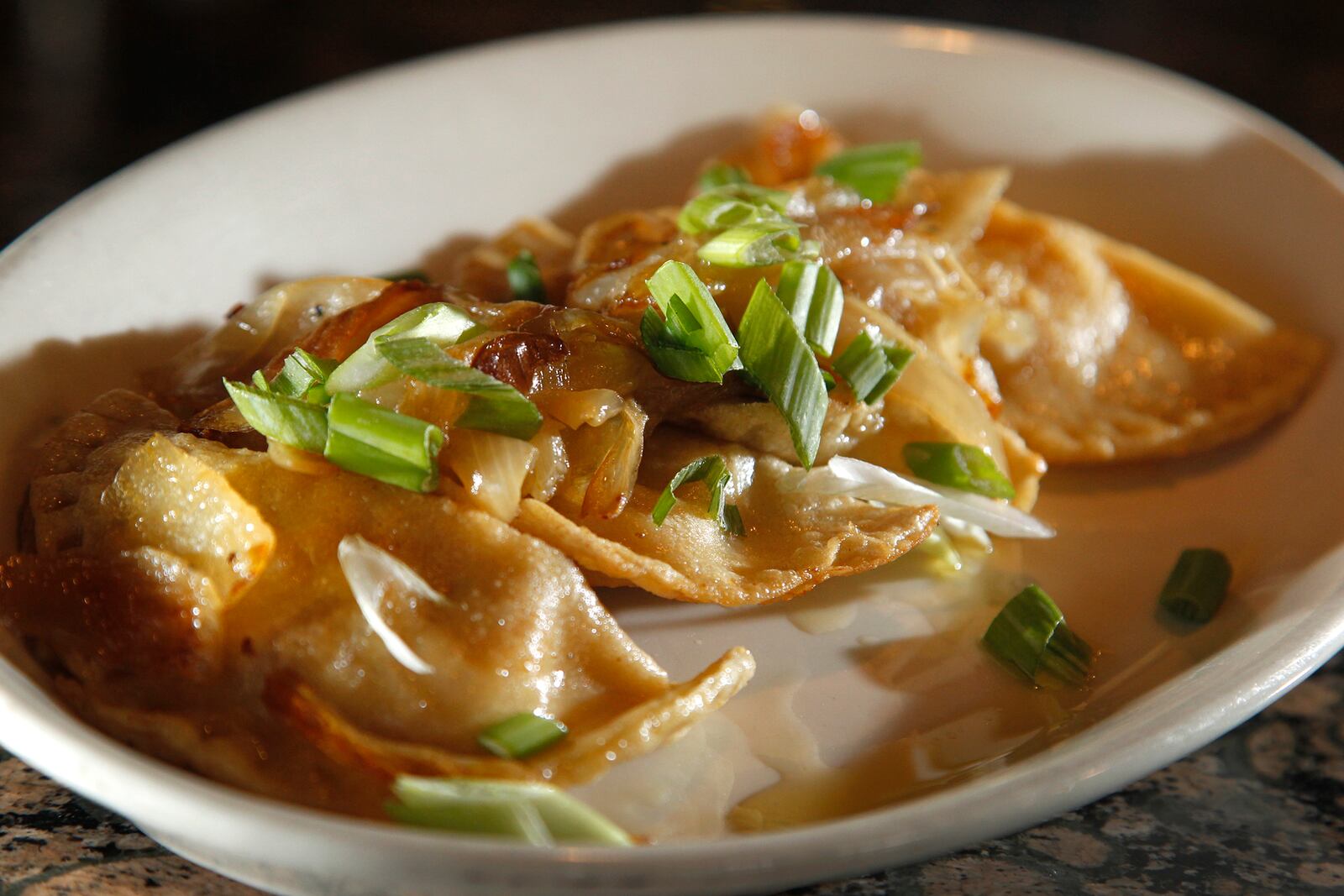 The Amber Rose Restaurant and Catering is a Dayton institution specializing in homemade Eastern European cuisine. On the menu is pierogi and onions, a mix of potato and cheese filled dumplings sauteed in butter and topped with carmelized onions.  LISA POWELL / STAFF