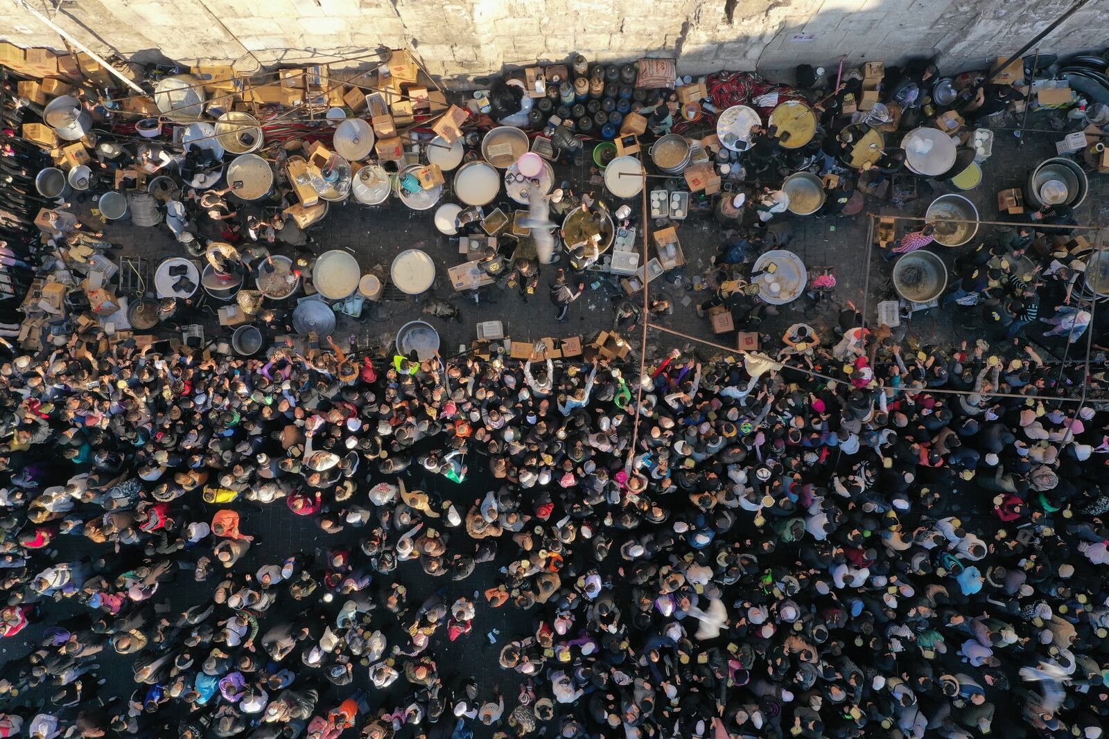 A crowd gathers outside the Umayyad Mosque during the distribution of free meals after Friday prayers in Damascus, Syria, Friday Jan. 10, 2025. (AP Photo/Ghaith Alsayed)