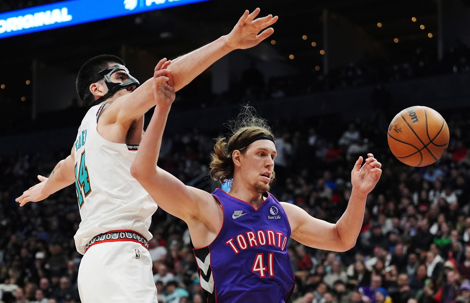 Memphis Grizzlies' Zach Edey (left) fouls Toronto Raptors' Kelly Olynyk (41) during second half NBA basketball action in Toronto on Wednesday, Feb. 5, 2025. (Frank Gunn/The Canadian Press via AP)