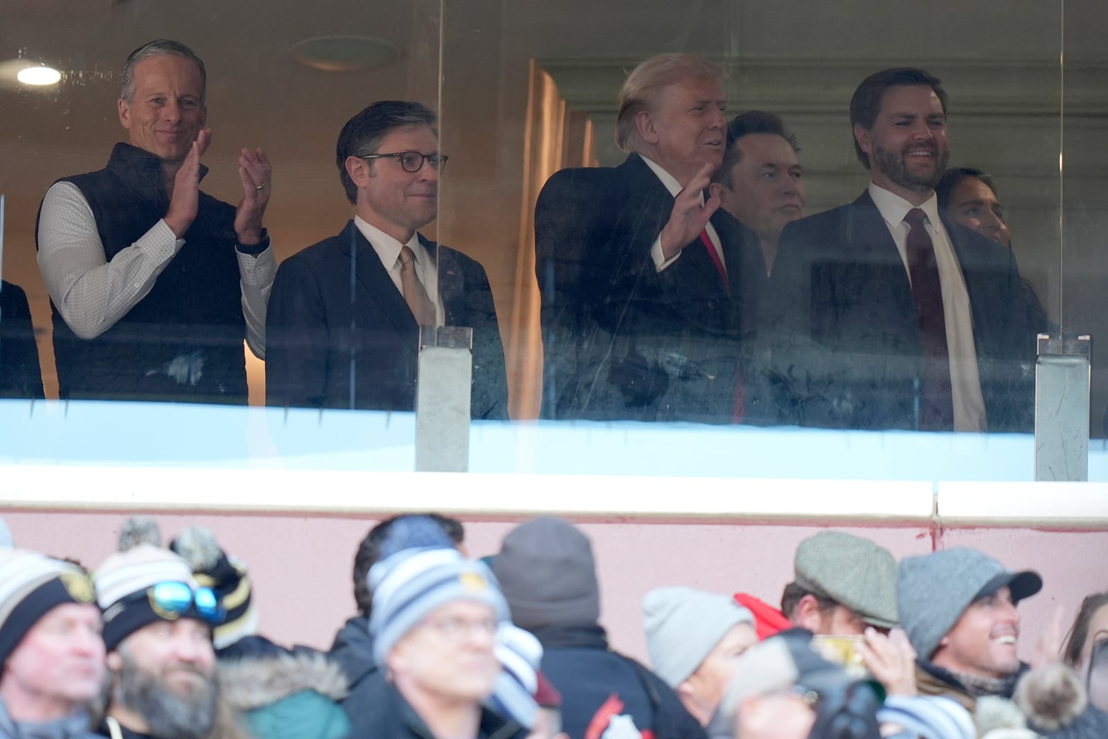 President-elect Donald Trump, center, joined by newly-elected Senate Majority Leader Sen. John Thune, R-S.D., from left, House Speaker Mike Johnson, Trump's pick for the planned Department of Government Efficiency Elon Musk, Vice President-elect JD Vance and Tulsi Gabbard, Trump's nominee to be Director of National Intelligence, attends the NCAA college football game between Army and Navy at Northwest Stadium in Landover, Md., Saturday, Dec. 14, 2024. (AP Photo/Stephanie Scarbrough)