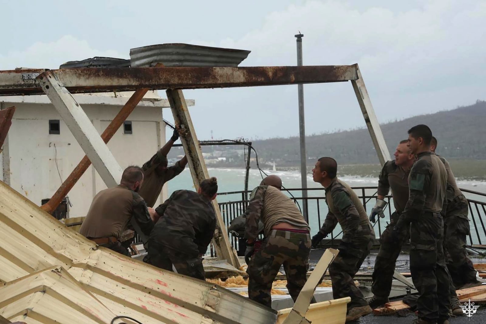 This photo provided Sunday Dec.15, 2024 by the French Army shows soldiers at work to restore a building in the French territory of Mayotte in the Indian Ocean, after Cyclone Chido caused extensive damage with reports of several fatalities, Saturday Dec.14, 2024. (Etat Major des Armées via AP)