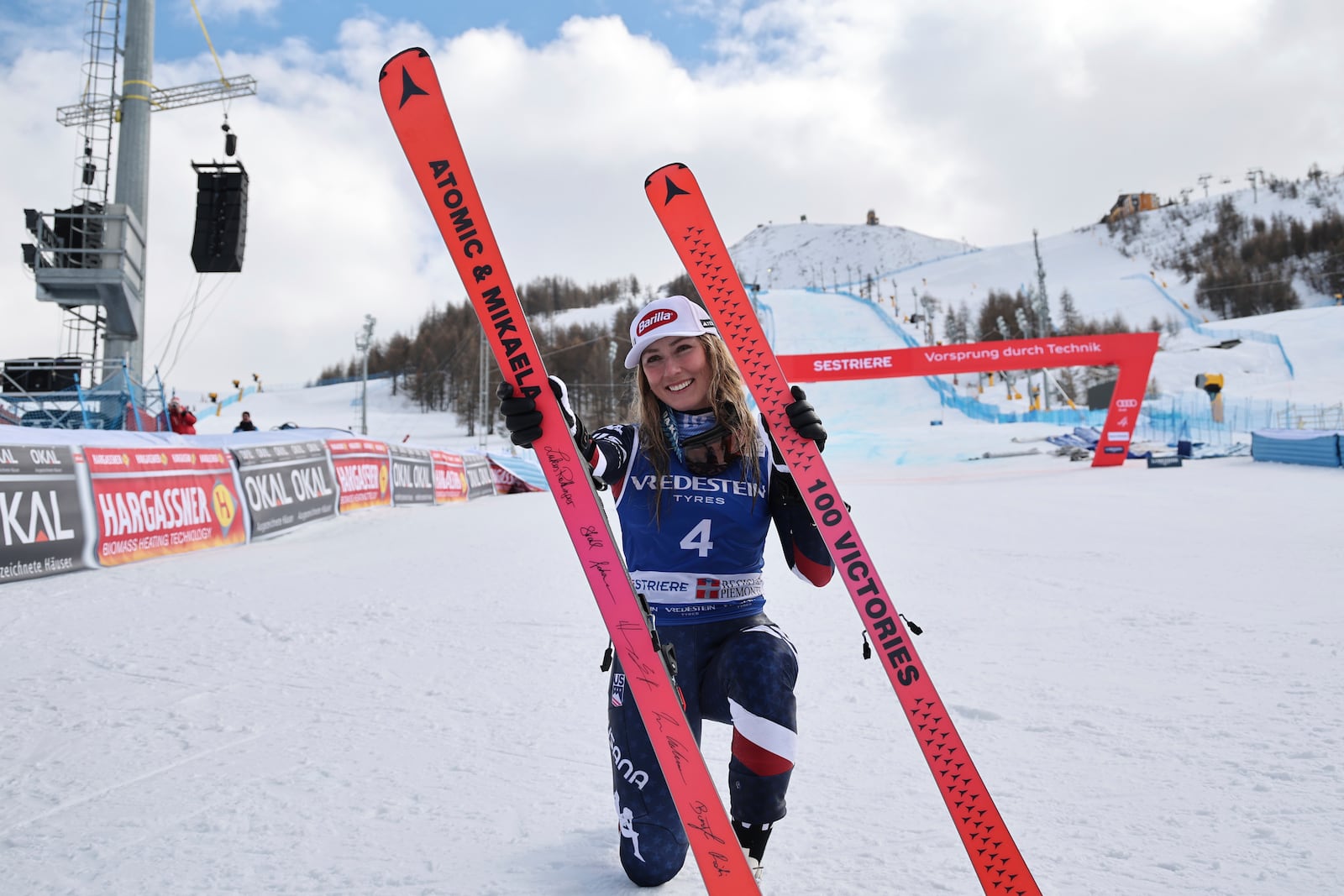 United States' Mikaela Shiffrin poses with her commemorative skis for her 100th victory after an alpine ski, women's World Cup slalom, in Sestriere, Italy, Sunday, Feb. 23, 2025. (AP Photo/Marco Trovati)