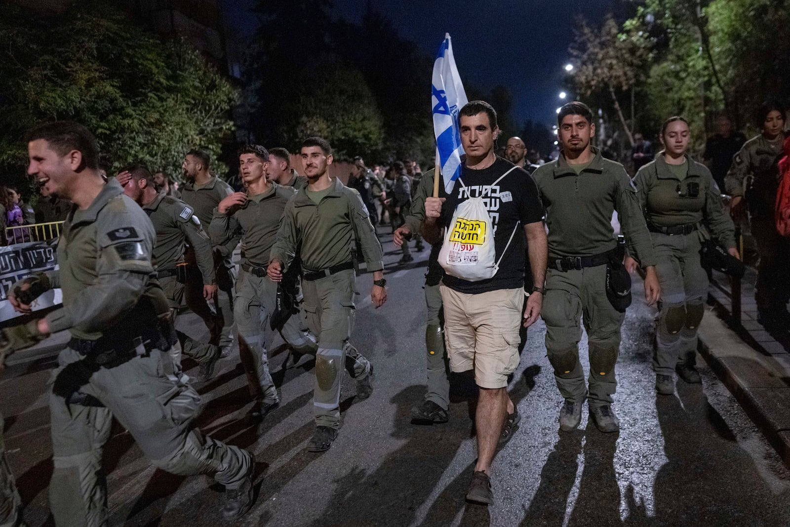 Police disperse people protesting against Prime Minister Benjamin Netanyahu's government and calling for the release of hostages held in the Gaza Strip by the Hamas militant group, near the Prime Minister's residence in Jerusalem, Monday, Oct. 28, 2024. (AP Photo/Ohad Zwigenberg)