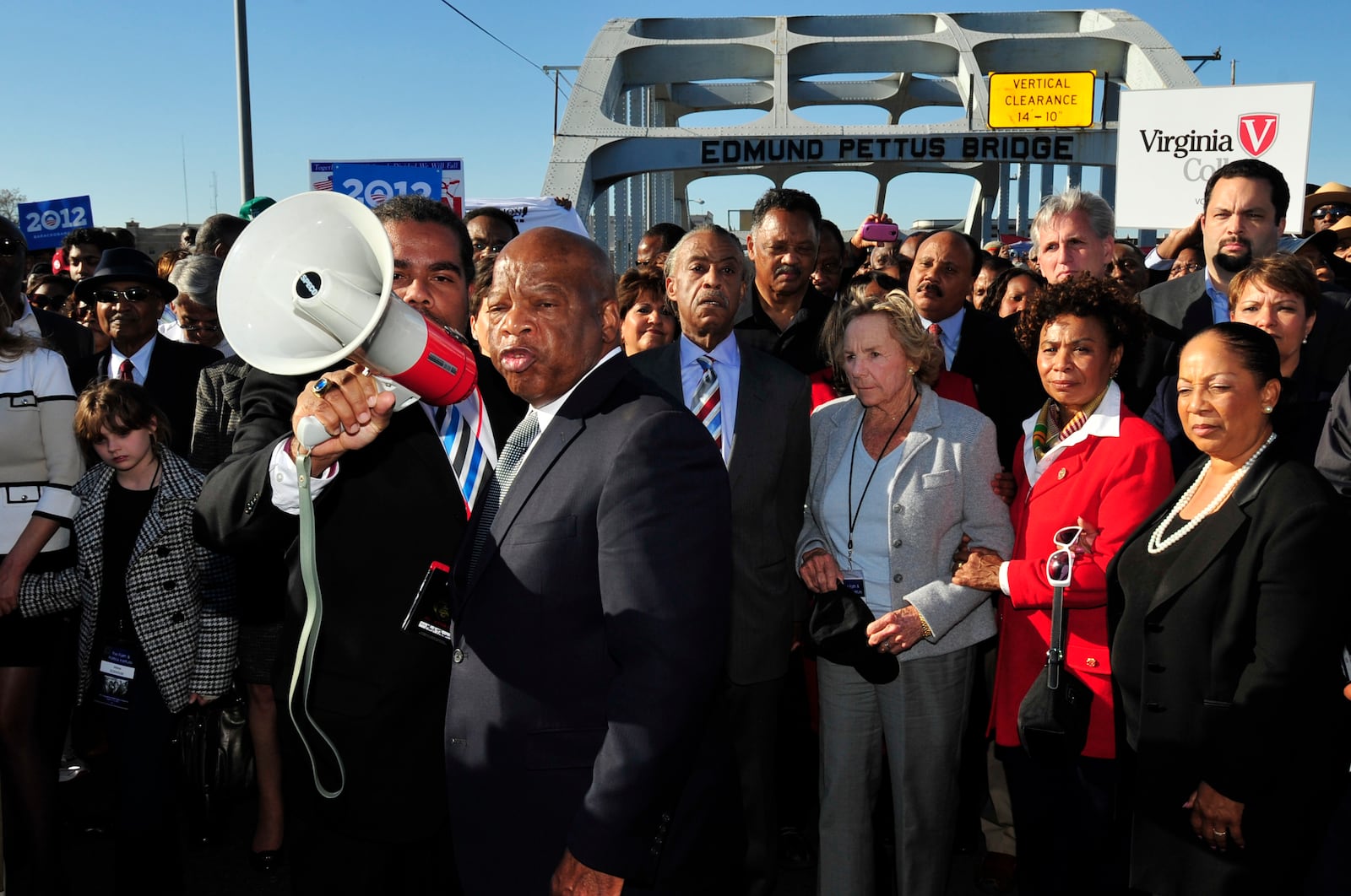 FILE - U.S. Rep. John Lewis, D-Ga., center, talks with those gathered, including Ethel Kennedy, center, and Rev. Jesse Jackson, on the historic Edmund Pettus Bridge during the 19th annual reenactment of the "Bloody Sunday" Selma to Montgomery civil rights march across the bridge in Selma, Ala., Sunday, March 4, 2012, 47 years after the historic march that led to the Voting Rights Act. (AP Photo/Kevin Glackmeyer, File)