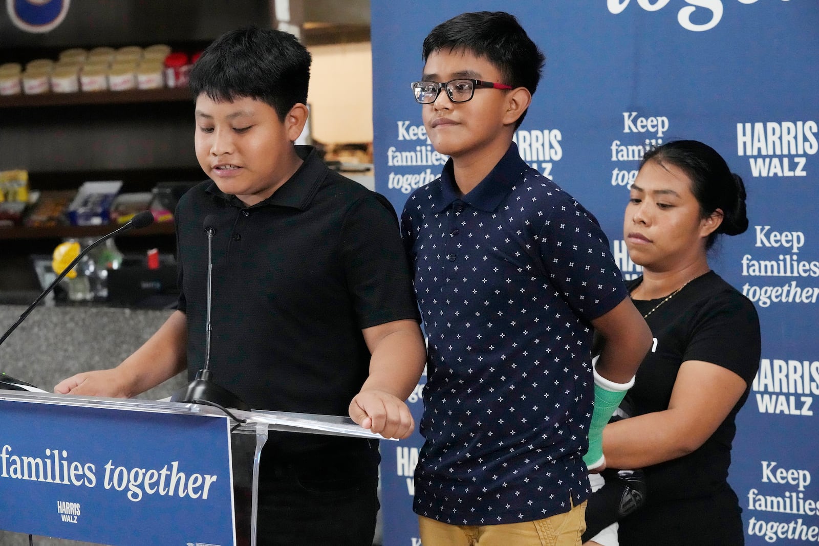 FILE- Christian and Hamilton, no last name given, speak during a Democratic Party campaign event about their experience on being separated from their mother Clairet when they crossed the U.S.- Mexico border during the Trump administration, Oct. 16, 2024, in Doral, Fla. (AP Photo/Marta Lavandier, File)