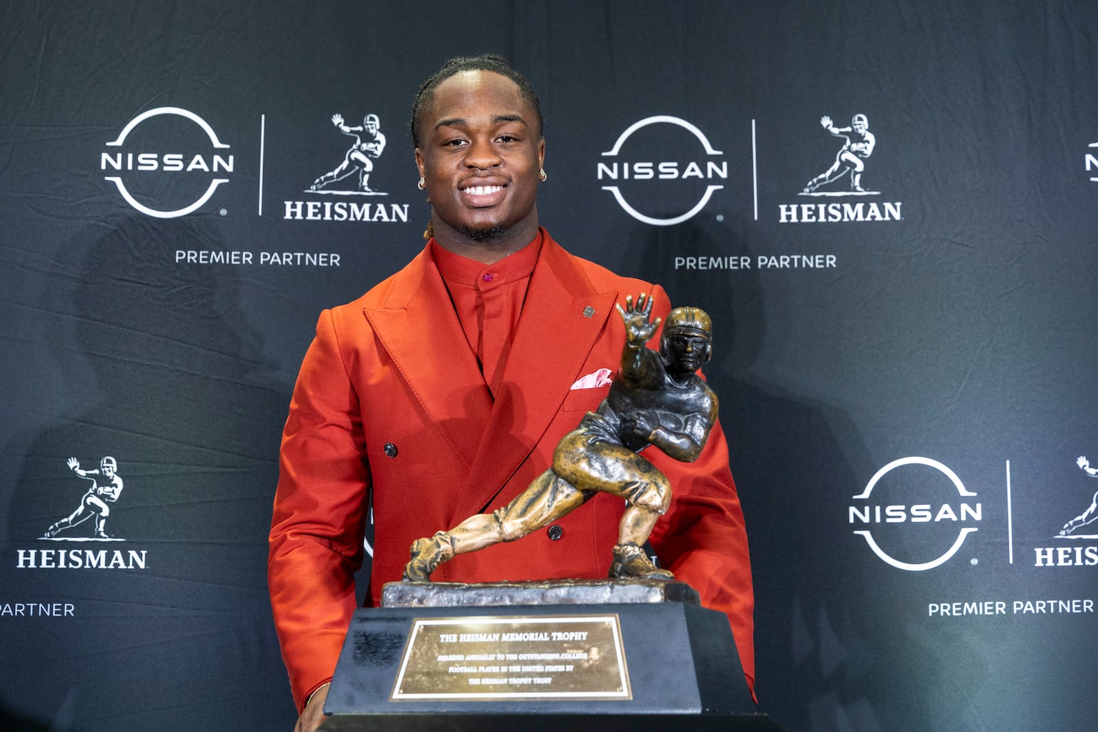 Heisman Trophy finalist Ashton Jeanty, of Boise State, stands with the trophy during a college football press conference, Saturday, Dec. 14, 2024, in New York. (AP Photo/Corey Sipkin)