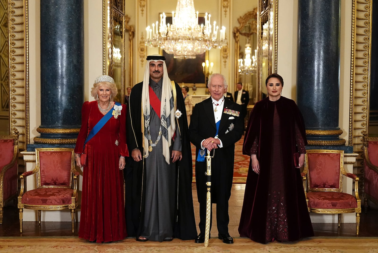 Britain's King Charles III, second right, and Queen Camilla, left, with the Emir of Qatar Sheikh Tamim bin Hamad Al Thani and his wife Sheikha Jawaher ahead of a state banquet at Buckingham Palace, in London, Tuesday, Dec. 3, 2024, during his state visit to the U.K. (Aaron Chown/Pool Photo via AP)