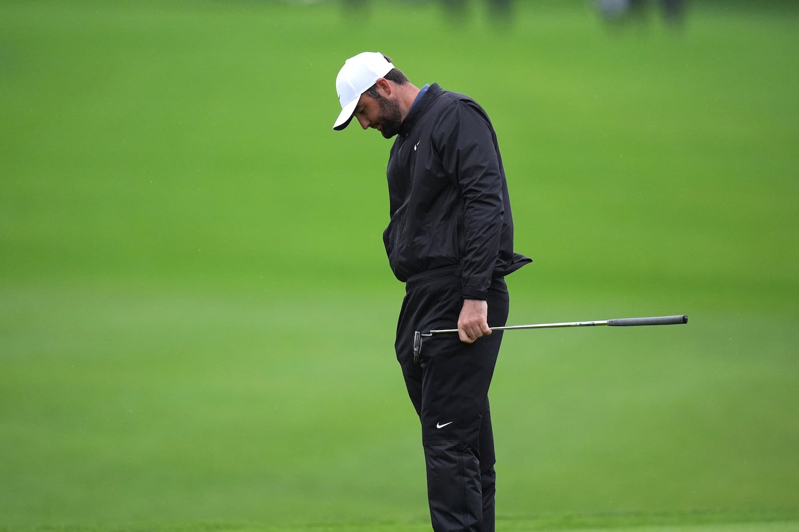 Scottie Scheffler reacts to missing his eagle putt on the 18th green of the South Course at Torrey Pines during the first round of the Genesis Invitational golf tournament Thursday, Feb. 13, 2025, in San Diego. (AP Photo/Gregory Bull)