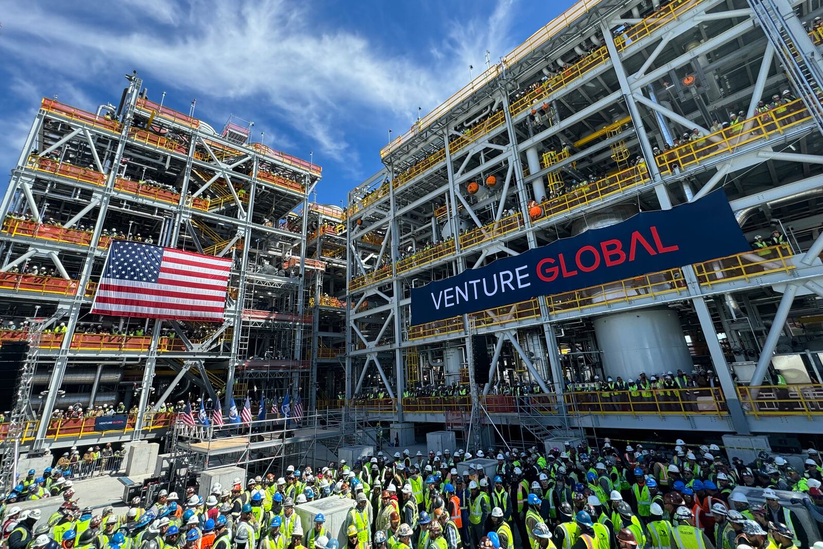 Venture Global workers await a rally with Secretary of Interior Doug Burgum and Secretary of Energy Chris Wright, Thursday, March 6, 2025, in Plaquemines Parish, La., where the company is investing billions of dollars in building out liquified natural gas export facilities. (AP Photo/Jack Brook)