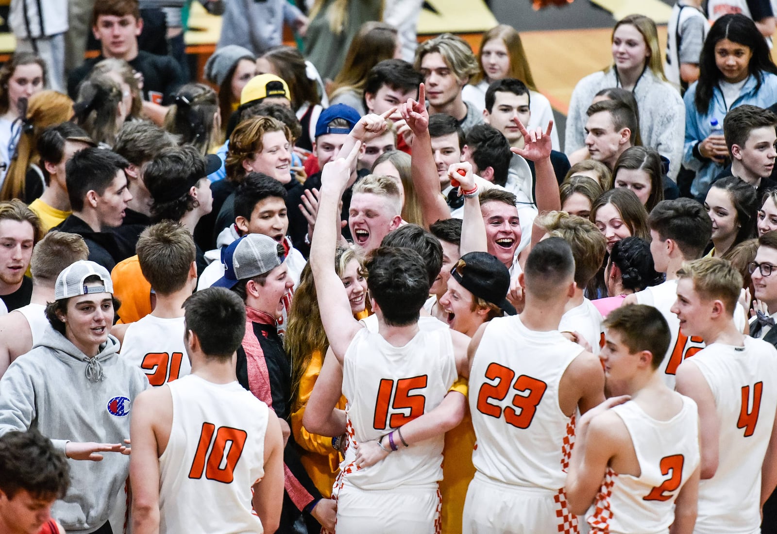 Waynesville’s players and students celebrate Friday night after the Spartans defeated visiting Madison 59-39. NICK GRAHAM/STAFF