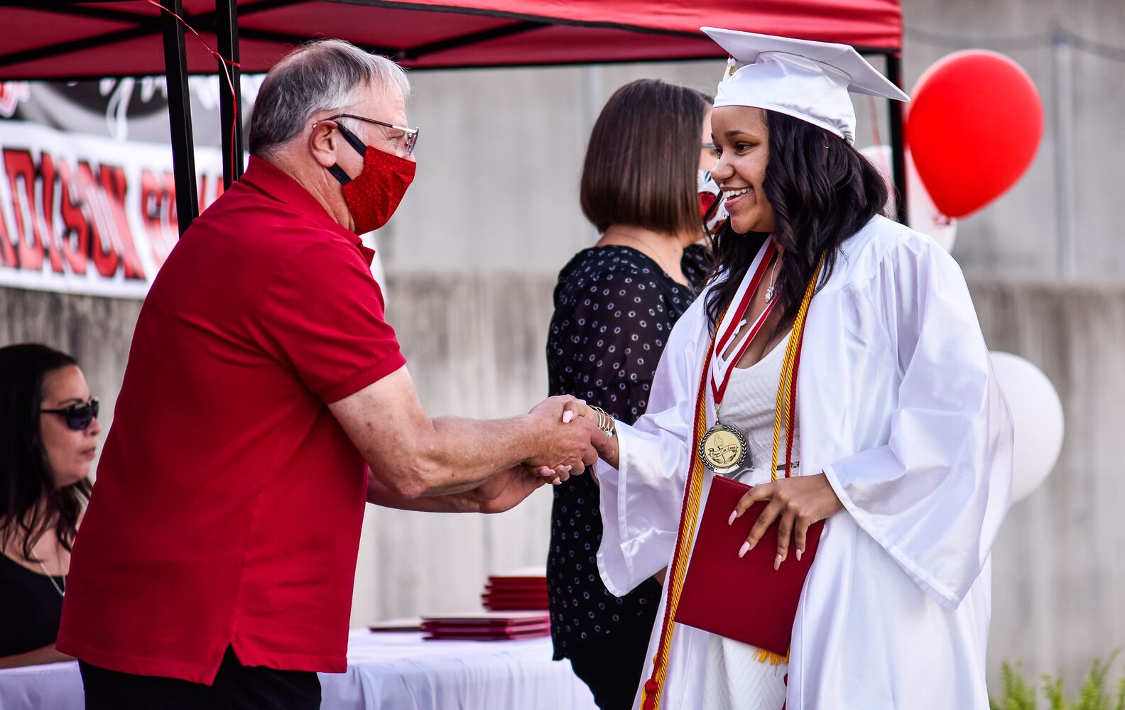 Madison High School drive-thru graduation ceremony at Land of Illusion