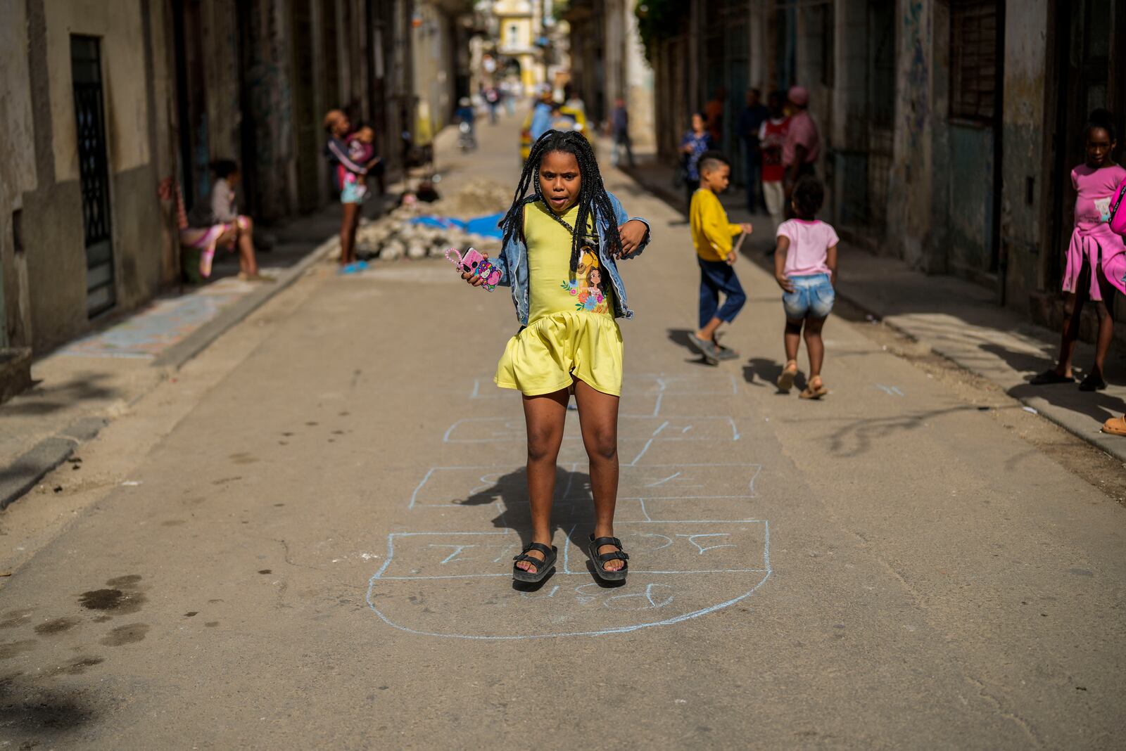 A girl plays in the street during a blackout in Havana, Cuba, Wednesday, Dec. 4, 2024. (AP Photo/Ramon Espinosa)