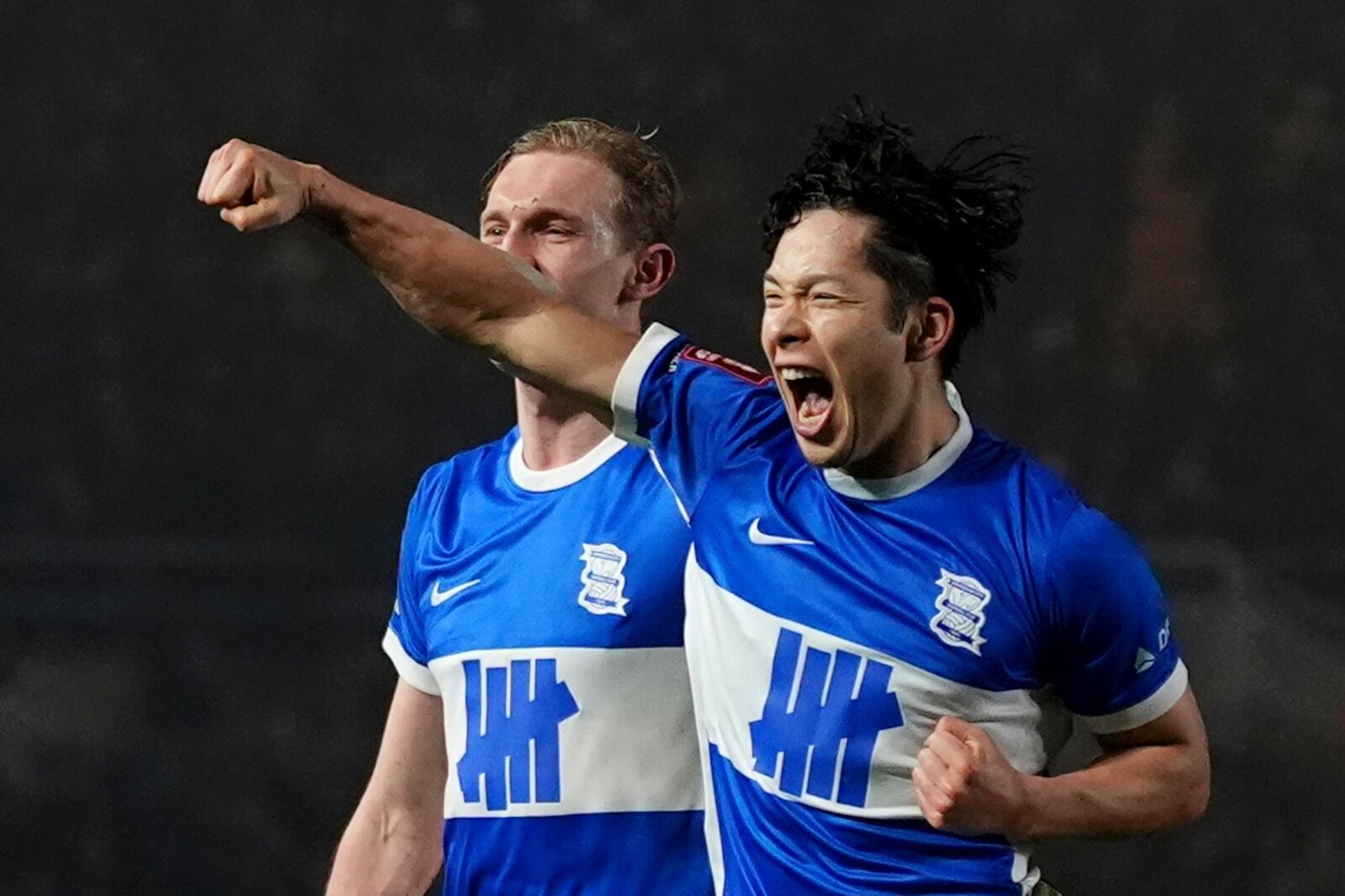 Birmingham City's Tomoki Iwata, right, celebrates scoring during the English FA Cup fourth round soccer match between Birmingham City and Newcastle United at in Birmingham, England, Saturday Feb. 8, 2025. (Bradley Collyer/PA via AP)