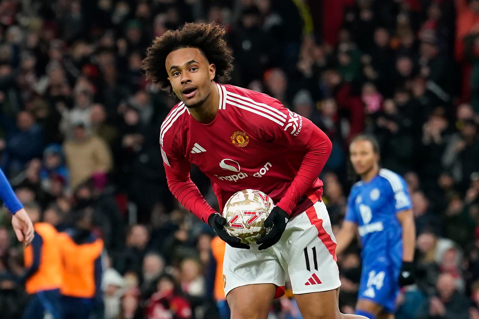 Manchester United's Joshua Zirkzee celebrates after scoring his side's first goal during the English FA Cup fourth round soccer match between Manchester United and Leicester City at the Old Trafford stadium in Manchester, England, Friday, Feb. 7, 2025. (AP Photo/Dave Thompson)