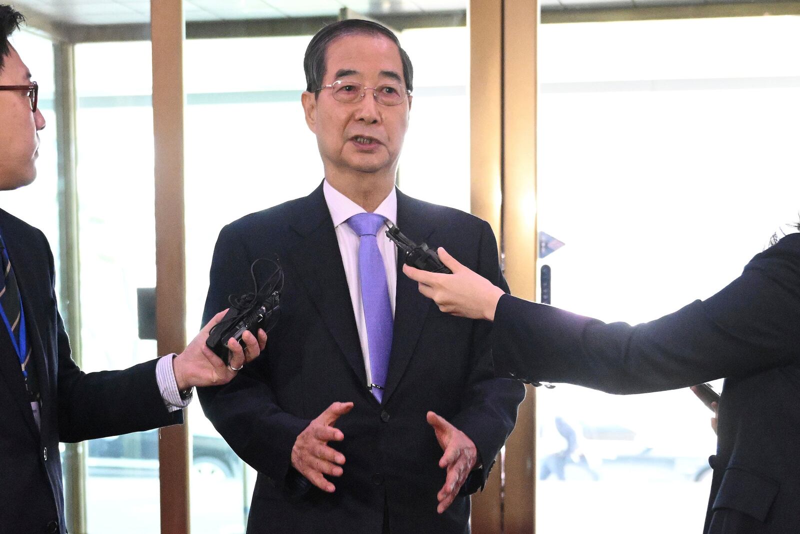 South Korean Prime Minister Han Duck-soo speaks to the media as he arrives at the Government Complex in Seoul Monday, March 24, 2025, after the Constitutional Court dismissed the impeachment of the prime minister. (Jung Yeon-je/Pool Photo via AP)