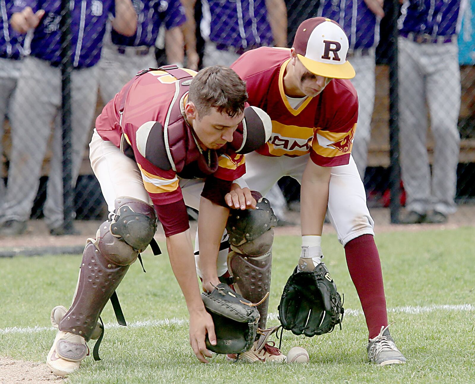 Ross catcher Andrew Beebe and third baseman Zach Evans bump into each other while going after a Columbus DeSales bunt during Friday’s Division II regional semifinal at Mason. CONTRIBUTED PHOTO BY E.L. HUBBARD