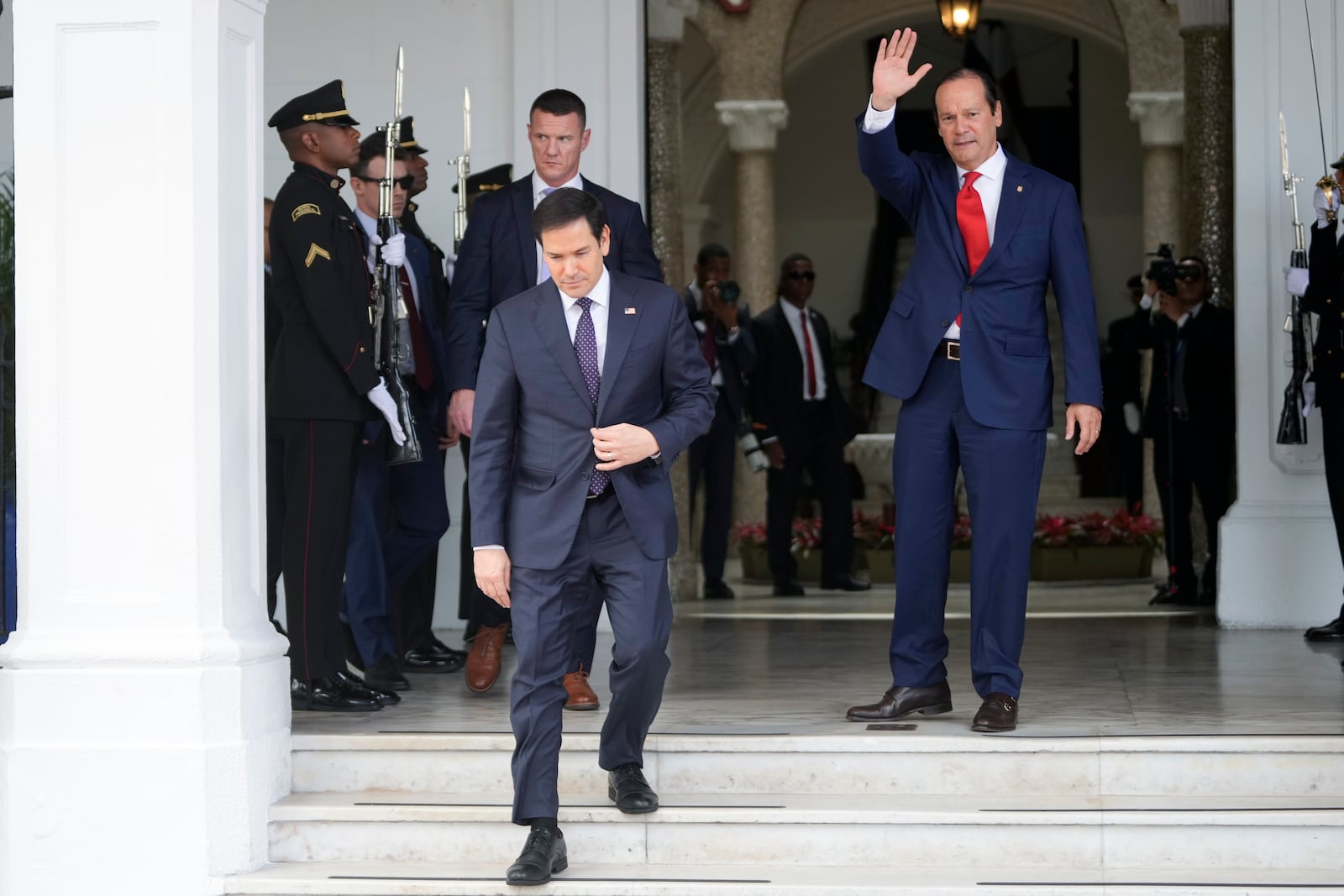 Panama's Foreign Minister Javier Martinez-Acha waves to U.S. Secretary of State Marco Rubio as he departs the presidential palace in Panama City after meeting with President Jose Mulino, Sunday, Feb. 2, 2025. (AP Photo/Mark Schiefelbein, Pool)