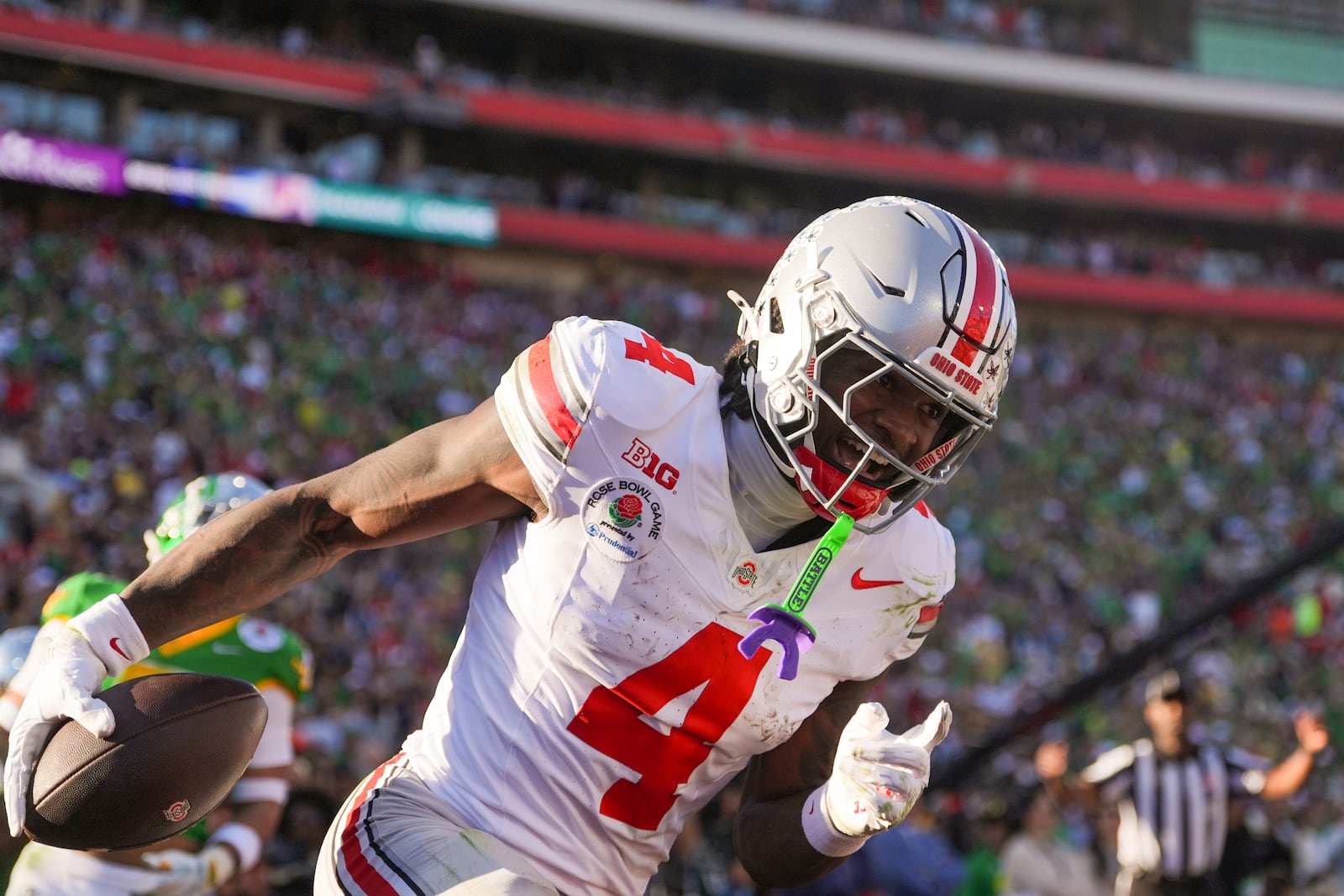 Ohio State wide receiver Jeremiah Smith (4) celebrates his touchdown against Oregon during the first half in the quarterfinals of the Rose Bowl College Football Playoff, Wednesday, Jan. 1, 2025, in Pasadena, Calif. (AP Photo/Mark J. Terrill)