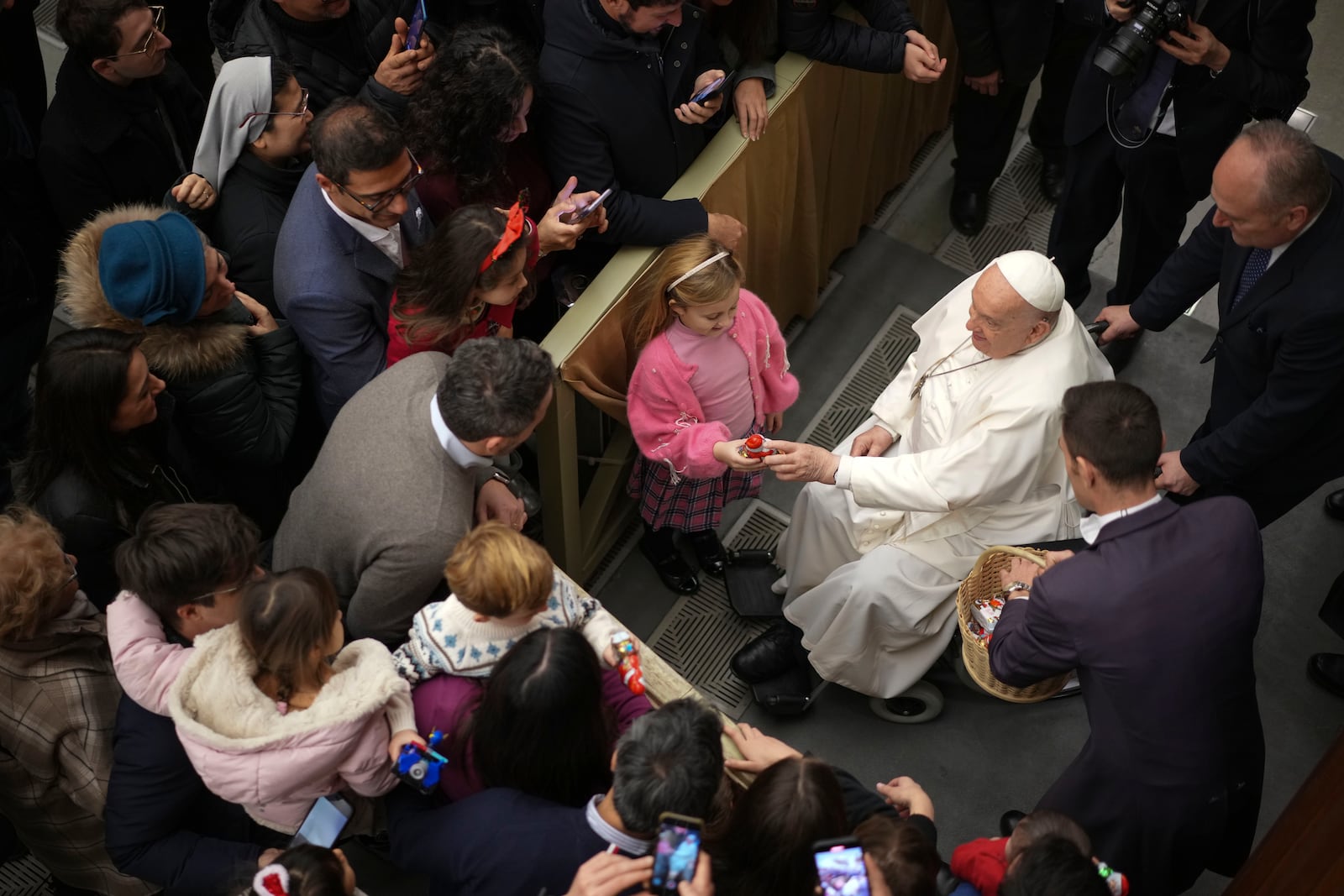 Pope Francis exchanges season greetings with Vatican employees, in the Paul VI Hall at the Vatican, Saturday, Dec. 21, 2024. (AP Photo/Andrew Medichini)