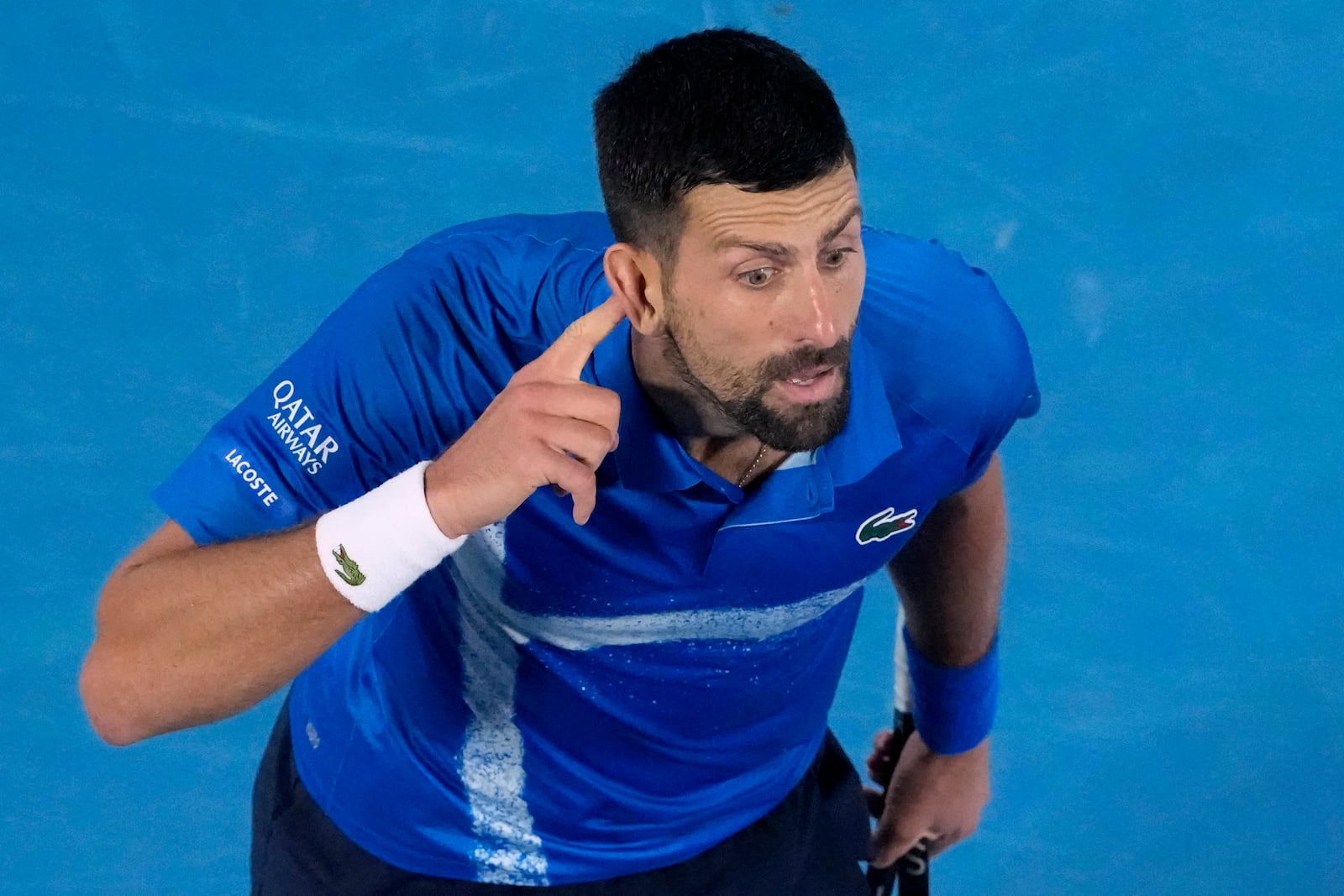 Novak Djokovic of Serbia gestures during his quarterfinal match against Carlos Alcaraz of Spain at the Australian Open tennis championship in Melbourne, Australia, Tuesday, Jan. 21, 2025. (AP Photo/Manish Swarup)