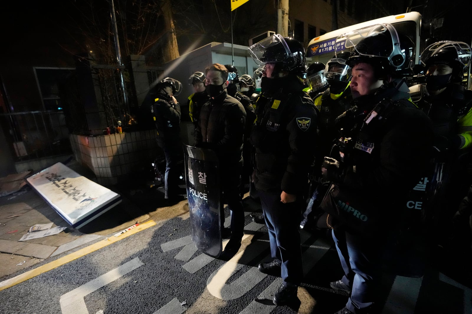 Police officers stand outside of the Seoul Western District Court after supporters of impeached South Korean President Yoon Suk Yeol broke into the court in Seoul, South Korea, Sunday, Jan. 19, 2025. (AP Photo/Ahn Young-joon)