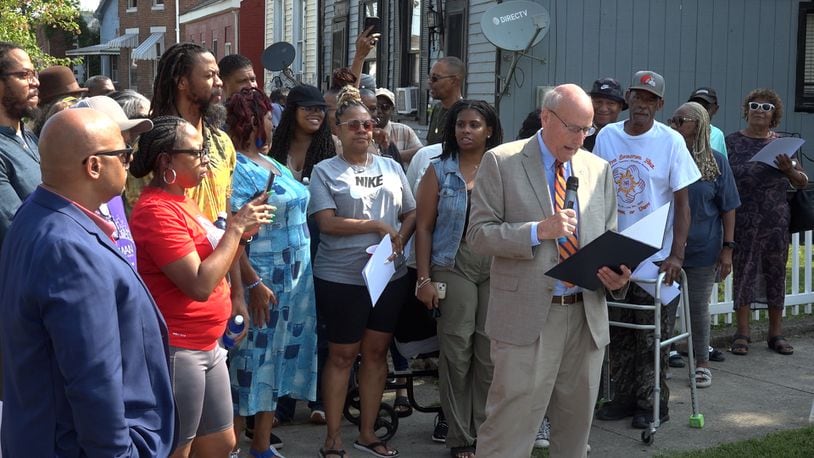 Music legend Roger Troutman, a Hamilton native, was celebrated on Tuesday morning with the honorary naming of Washington Street as Roger Troutman Street. Troutman, who died in 1999 in Dayton, grew up on Washington Street where he created his band Zapp, which included his brothers and other musicians. He famously collaborated with big names of the funk, R&B and hip-hop industry, including Snoop Dogg, Dr. Dre and Tupac Shakur. Pictured is Mayor Pat Moeller reading a proclamation at the honorary naming ceremony surrounded by Roger Troutman's family. PROVIDED/TVHAMILTON