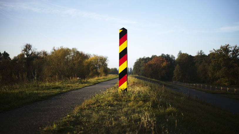 FILE - A border pole in German national colours marking the German border with Poland at the river Oder near the city Lebus, Germany, Oct. 28, 2021. (AP Photo/Markus Schreiber, File)