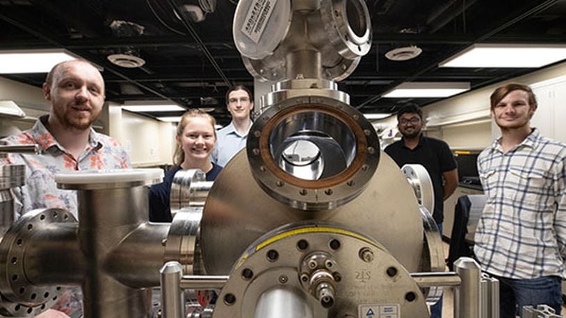 Perry Corbett, assistant professor of Physics, left, stands with students Sara McGinnis, Carter Wade, Lakshan Don Manuwelge Don and Nate Price around the newly donated ultra-high vacuum scanning tunneling microscope. PHOTO: JEFF SABO/CONTRIBUTED