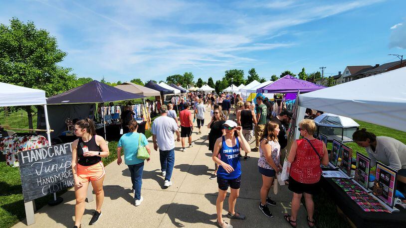 Visitors stroll through Hamilton Flea, a monthly urban artisan market, Saturday, May 14, 2022 at Marcum Park in Hamilton. NICK GRAHAM/STAFF