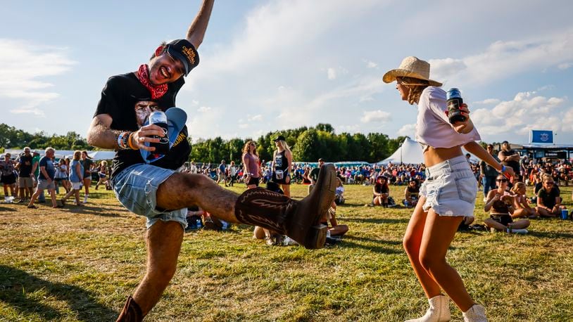 Erik Thurza and Jayna Gilkey dance on day three of the first Voices of America Country Music Fest Saturday, Aug. 12, 2023 on the grounds of National Voice of America Museum of Broadcasting in West Chester Township. NICK GRAHAM/STAFF