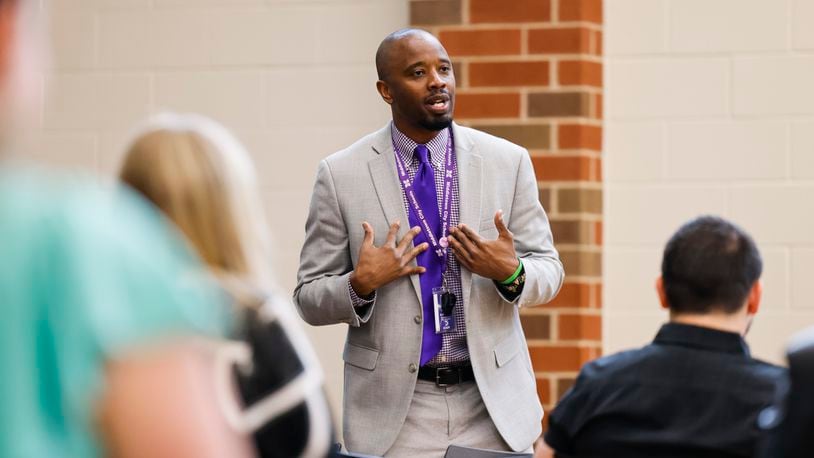 Kee Edwards, senior director of human resources for the Middletown City School District, speaks to applicants during a job fair for the school district two years ago. He recently sent out letters alerting some staff their contracts won't be renewed next school year. NICK GRAHAM/STAFF