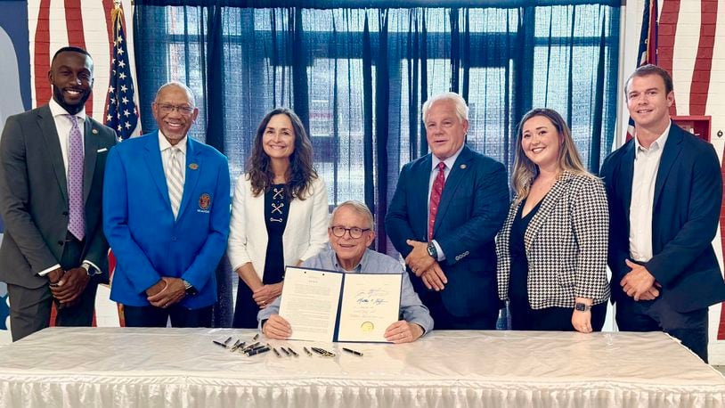 Ohio Gov. Mike DeWine signs an anti-hooning bill that was backed by Dayton Mayor Jeffrey Mims, Jr., along with Dayton-area state legislators Reps. Phil Plummer, R-Butler Twp., and Andrea White, R-Kettering. JULY 24, 2024.