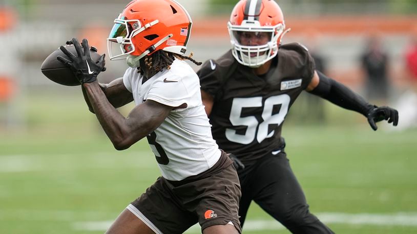 Cleveland Browns wide receiver Jerry Jeudy, left, catches a pass in front of linebacker Jordan Hicks (58) during NFL football practice in Berea, Ohio, Wednesday, May 22, 2024. (AP Photo/Sue Ogrocki)