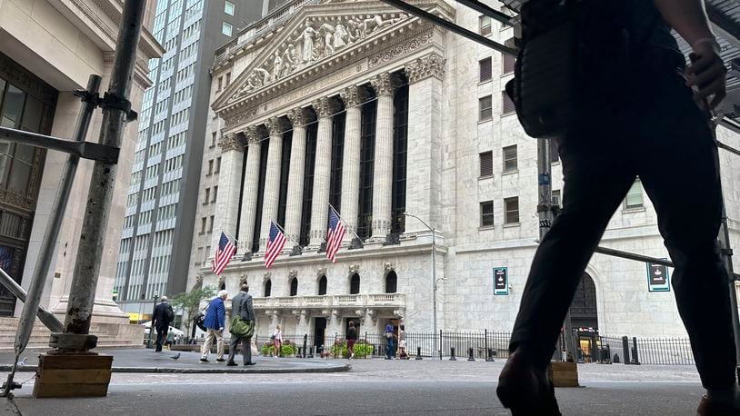 FILE - People pass the New York Stock Exchange on Aug. 27, 2024, in New York. (AP Photo/Peter Morgan, File)