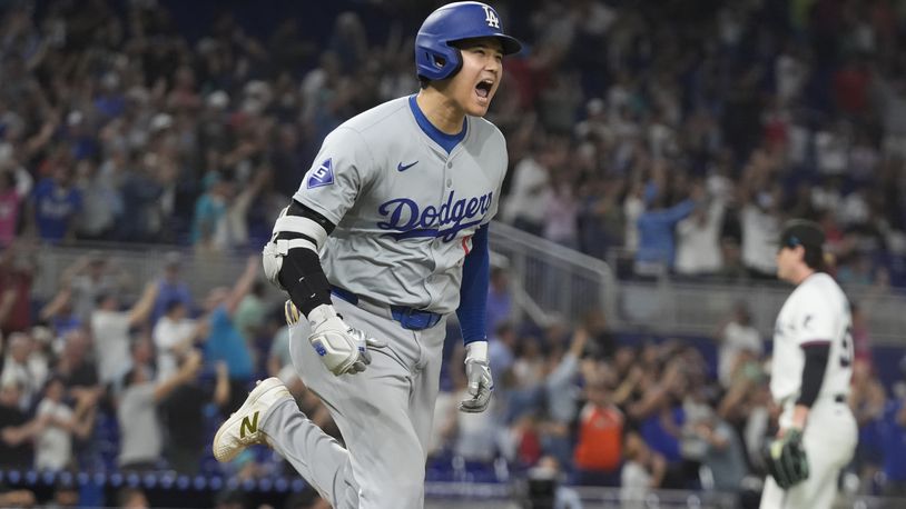 Los Angeles Dodgers' Shohei Ohtani (17) reacts after hitting his 50th home run of the season during the seventh inning of a baseball game against the Miami Marlins, Thursday, Sept. 19, 2024, in Miami. (AP Photo/Marta Lavandier)