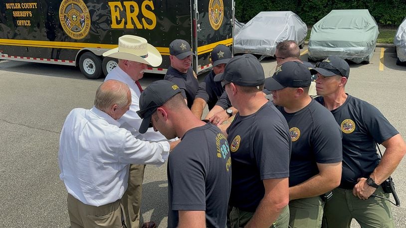 Butler County Sheriff Richard Jones, wearing a cowboy hat, participates in a huddle Wednesday, July 31, 2024, with the nine-member Emergency Response Services swiftwater/flood search and rescue team deploying to New Mexico. CONTRIBUTED