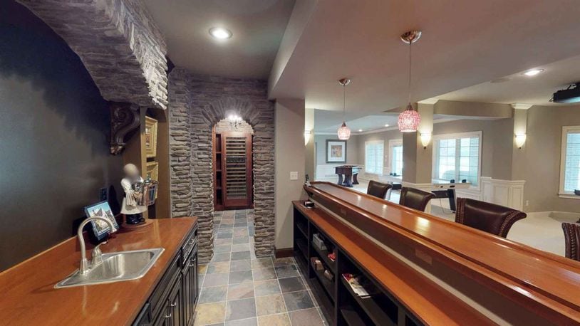 A Warren County home now on the market features multiple bars and fireplaces. The 4-bedroom, four-and-half bath home at 8672 Emerald Isle in Deerfield Twp. is listed for $1,465,000. CONTRIBUTED